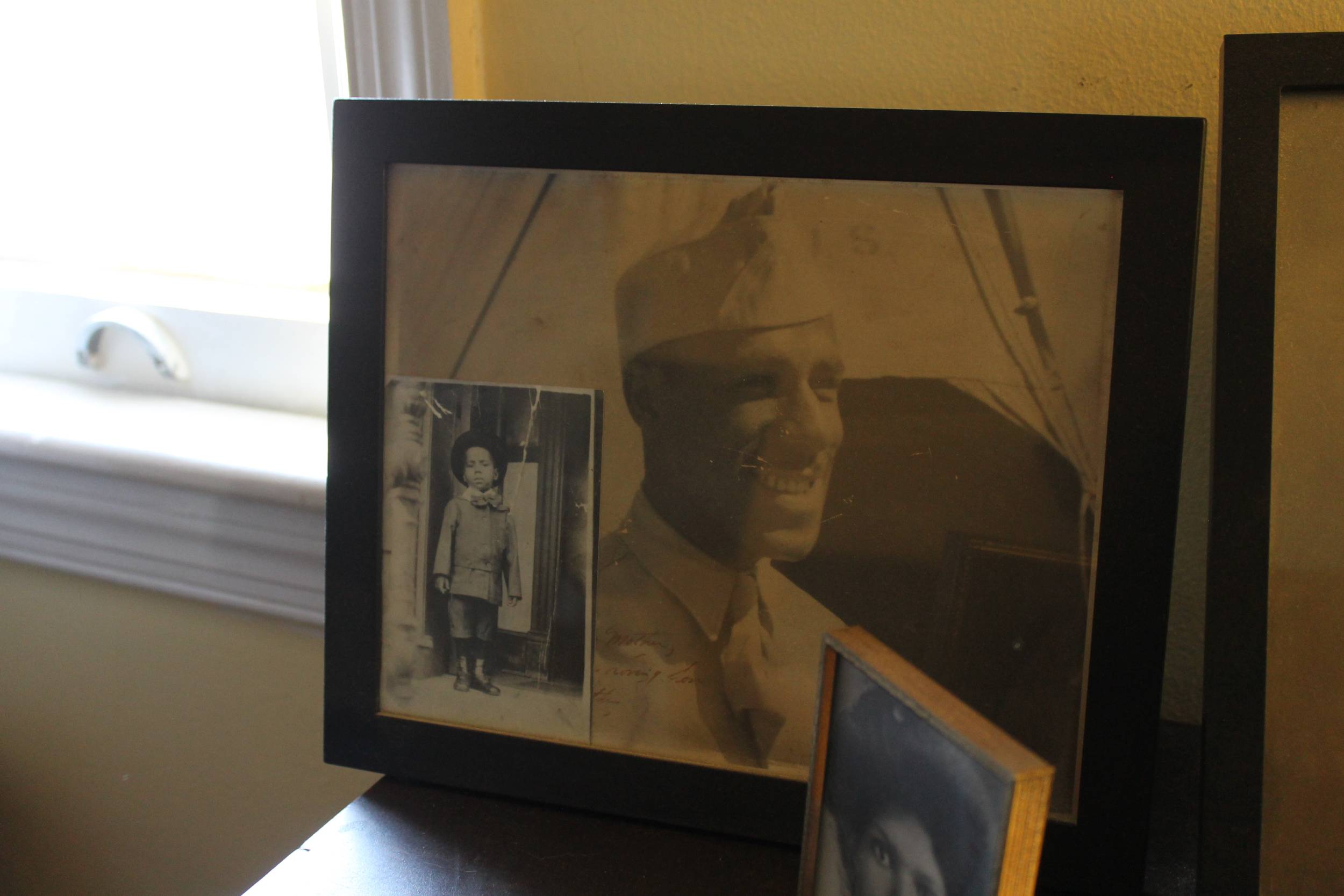 Photo of a framed portrait sitting on a table.