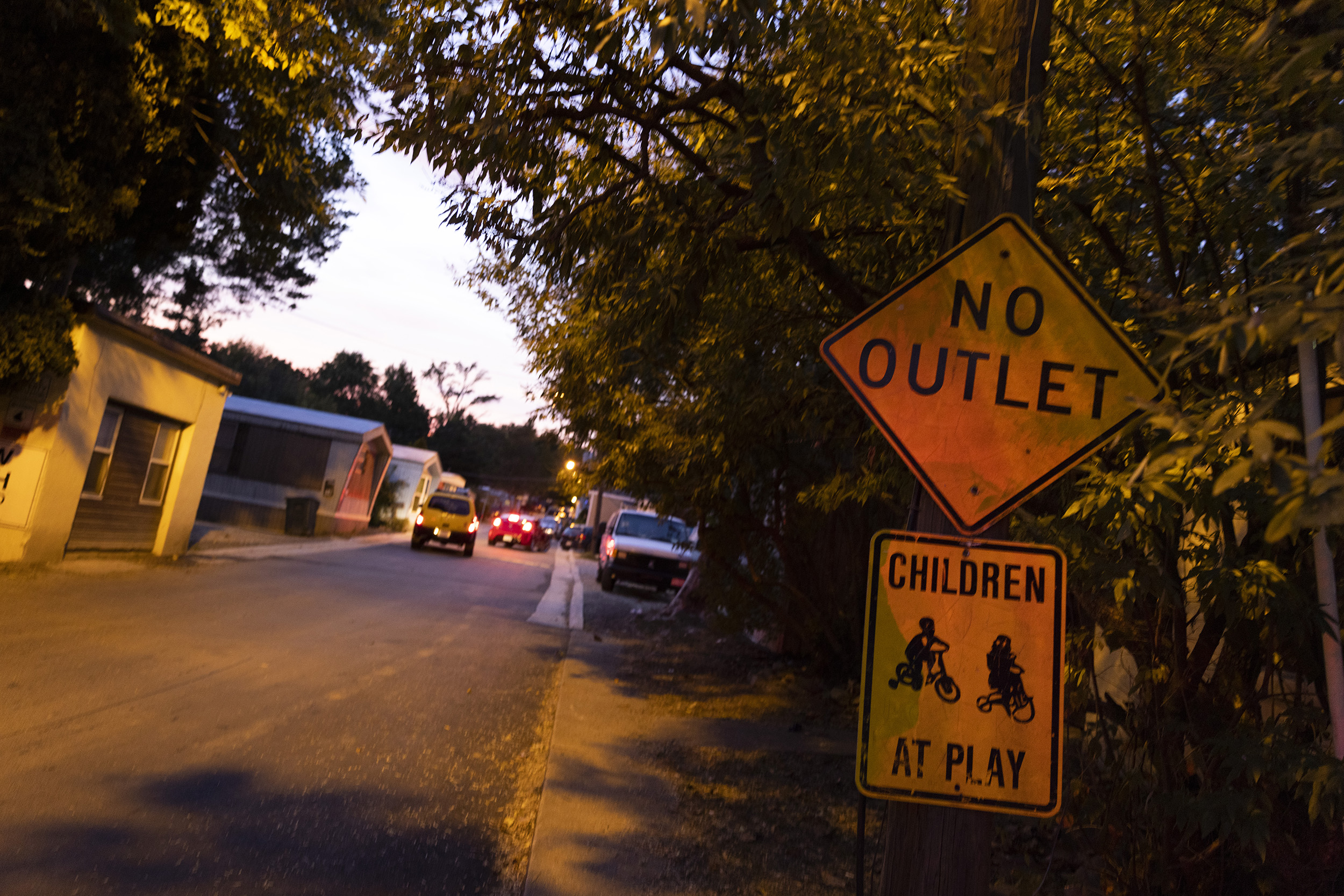 Photo of two signs. The top one says "no outlet" and the one under it says "children at play"
