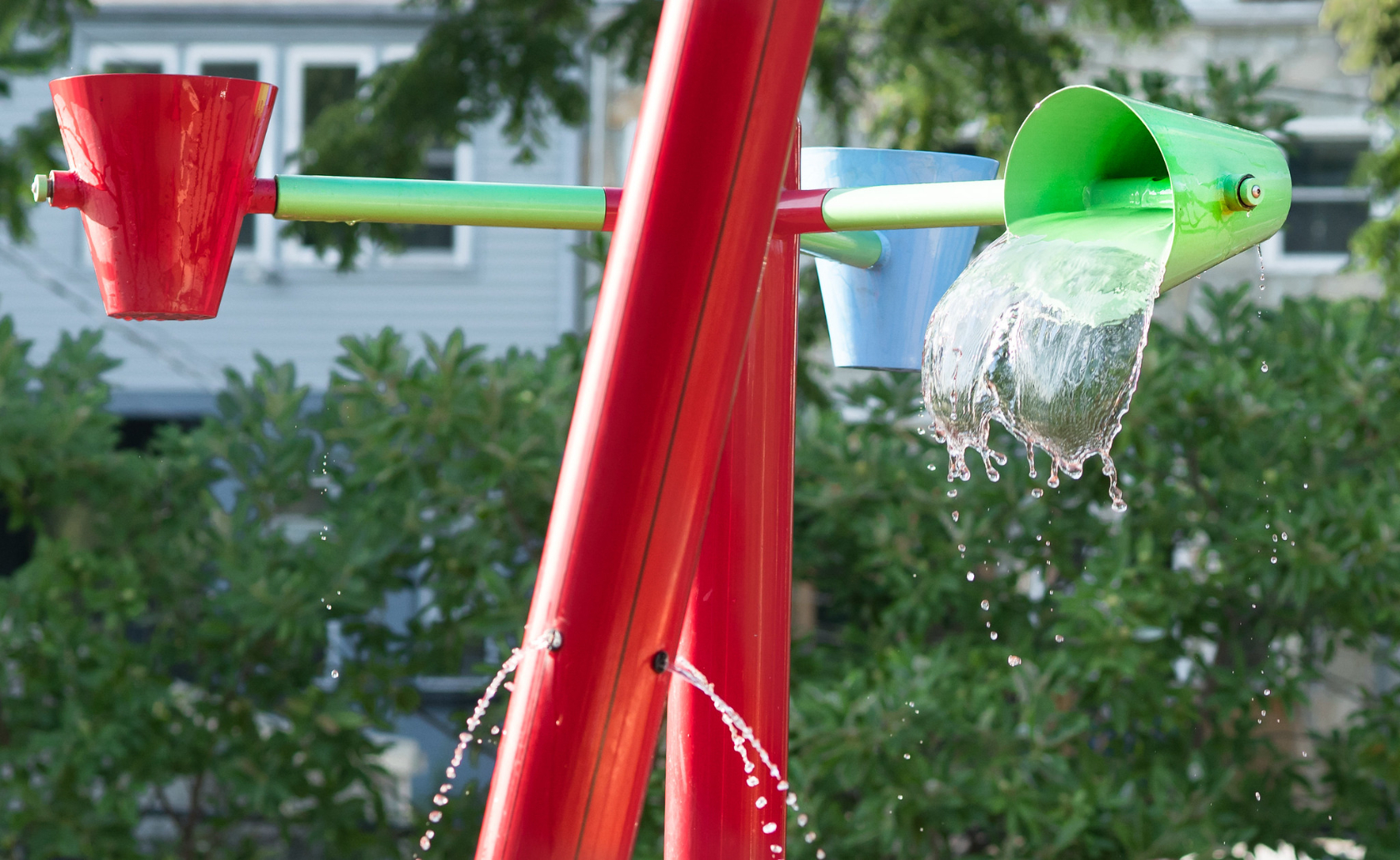 Photo of brightly colored poles and pales spraying water