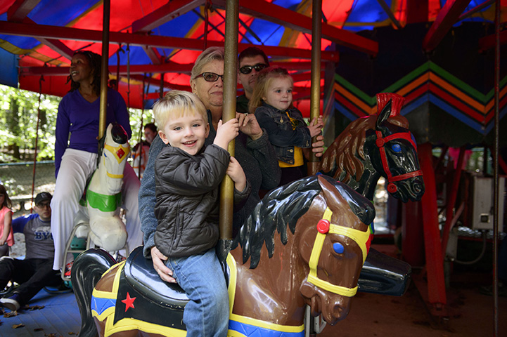 Photo of children and parents on a carousel