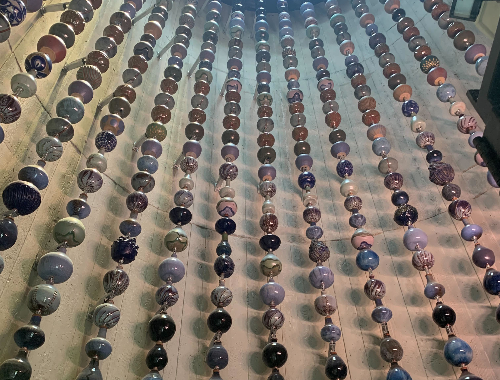 Photo showing 12 columns of ceramic vessels up close