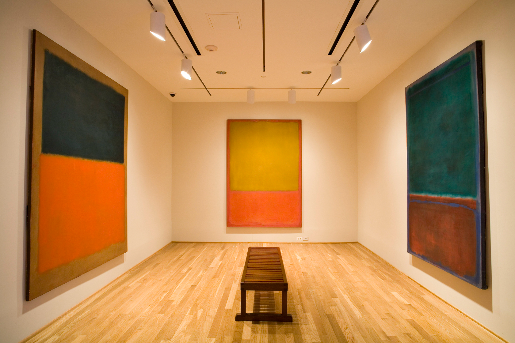 Image of the Rothko Room in The Phillips Gallery in Washington DC; a room with large canvas paintings.