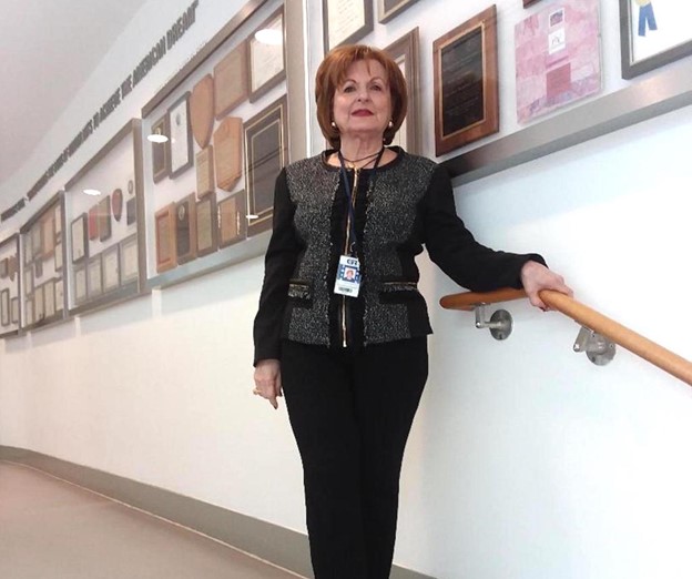 Photo showing five awards cases on the wall behind Gutiérrez.