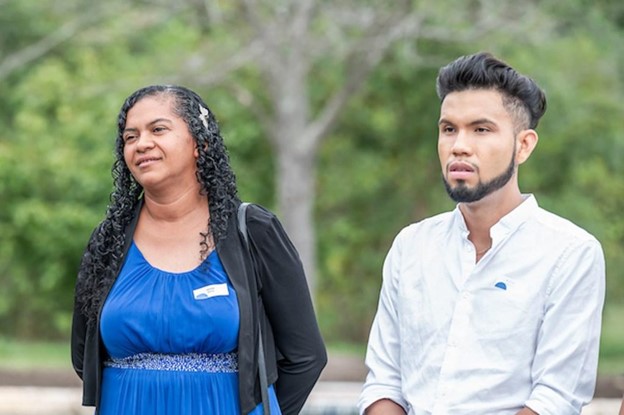 Photo of two people standing outside.