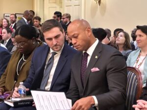 Photo showing Wes Moore and another person looking at sheets of paper together.